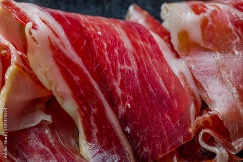 Spanish Jamon (Hamon), parma ham sliced on plate extreme macro close up