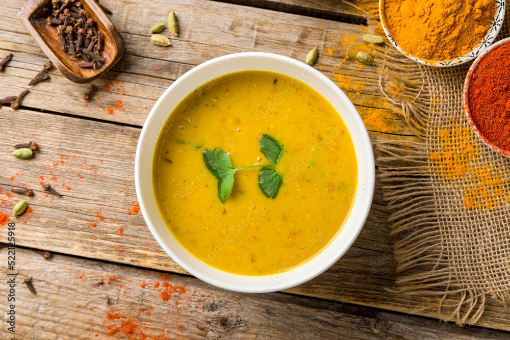 Spicy Lentil Soup on bowl, indian cuisine on old wooden table top view Spicy Lentil Soup on bowl, indian cuisine on old wooden table top view