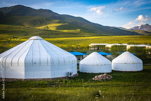yurt camp in suussamyr valley in kyrgyzstan, mountain landscape, central asia, green valley, pasture