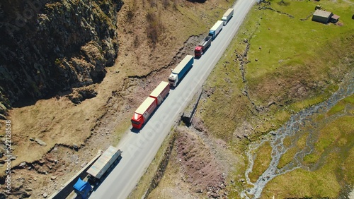 trucks forming a long queue and waiting to pass the border between Georgia and Russia, Kazbegi, Georgia. High quality photo photo