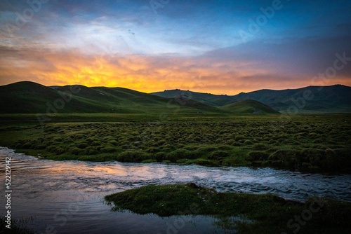Fototapeta Naklejka Na Ścianę i Meble -  river, sunset at mountains in Kyrgyzstan, Song-Köl, Central Asia,