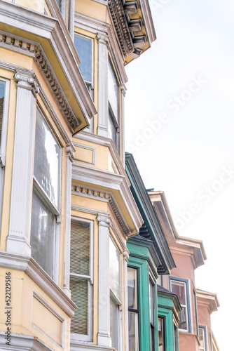 Photography Bay windows of victorian townhouses against the white sky background at San Fran