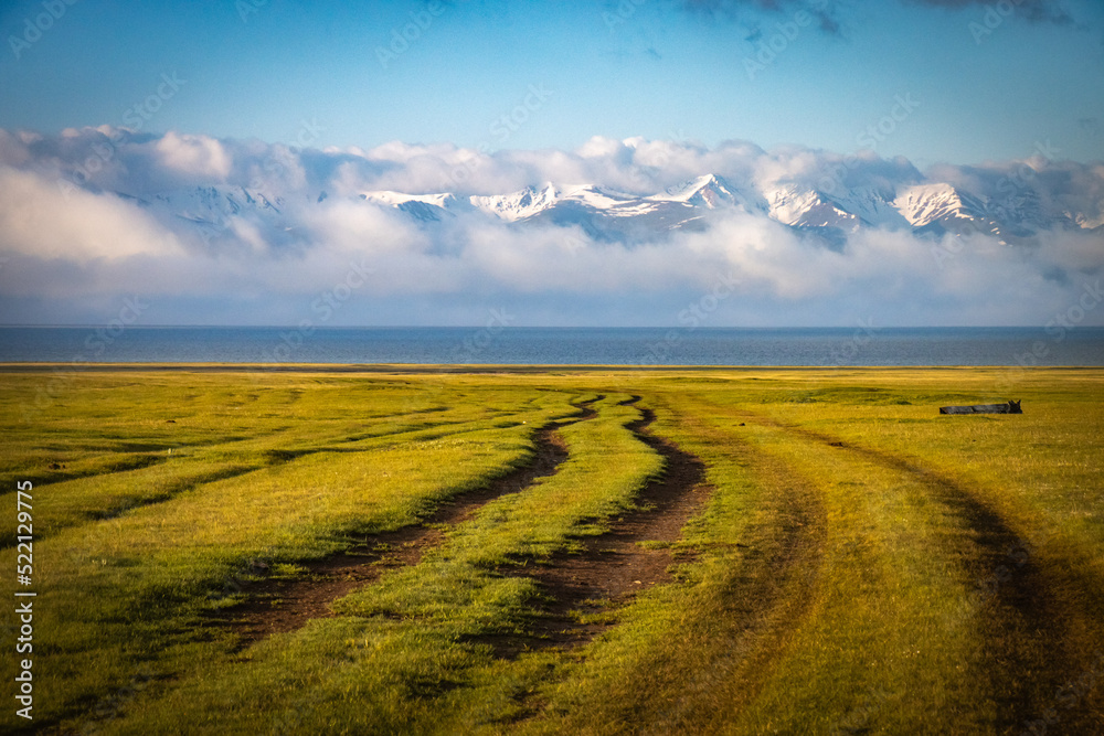 Obraz premium sunrise over the field, shore of song-köl lake, krygyzstan, central asia, mountains, high altitude