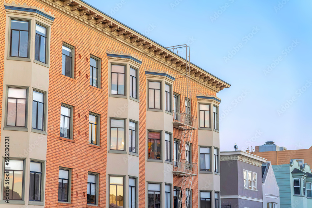 Apartment building with bricks and bay windows along with the townhouses at San Francisco, CA