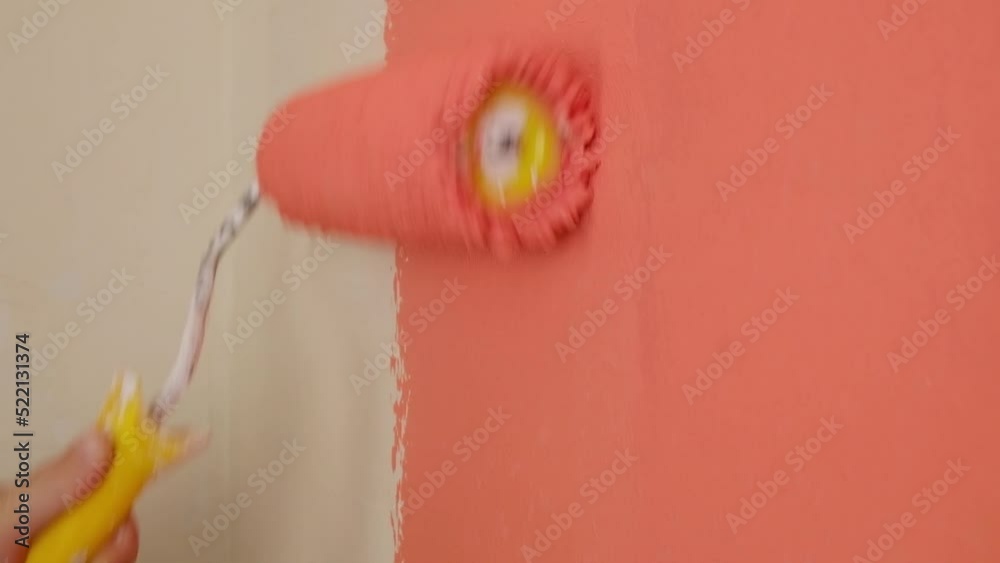 paint the walls in peach color with a roller, refurbishment in the room High quality FullHD footage