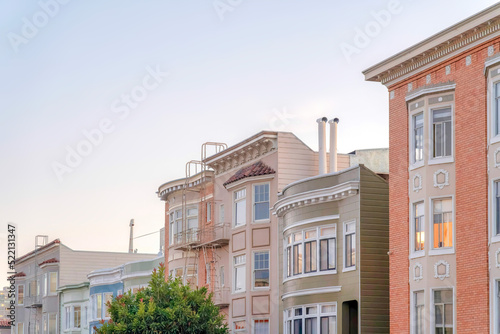 Photography Row of townhomes and apartments with victorian style exterior in San Francisco,