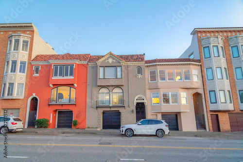 Rowhouses in San Francisco, California with metal gate doors and attached garages © Jason