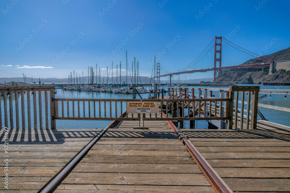 Closed dock with signages at the harbor against the Golden Gate Bridge at San Francisco, CA Closed dock with signages at the harbor against the Golden Gate Bridge at San Francisco, CA