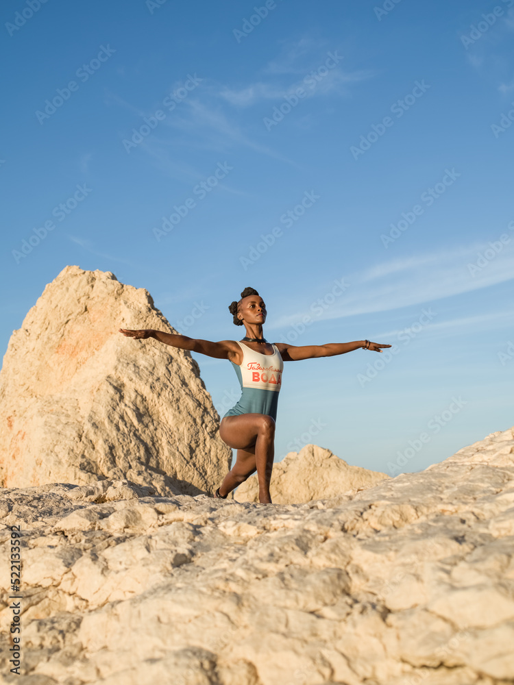 Black woman doing Crescent Lunge with outstretched arms Black woman doing Crescent Lunge with outstretched arms