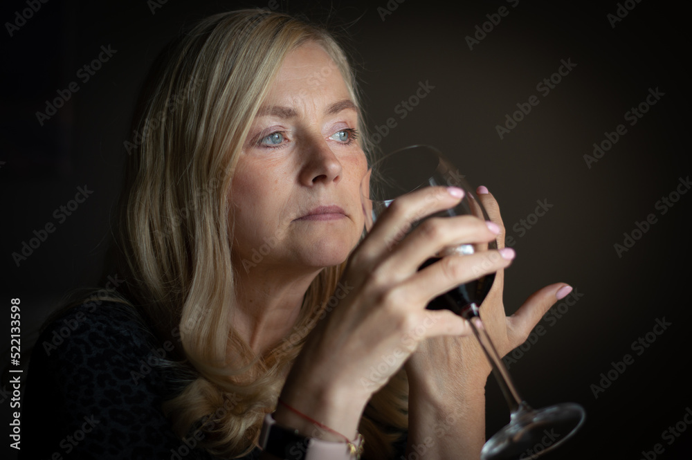 Woman in contemplation with a glass of red whine Woman in contemplation with a glass of red whine