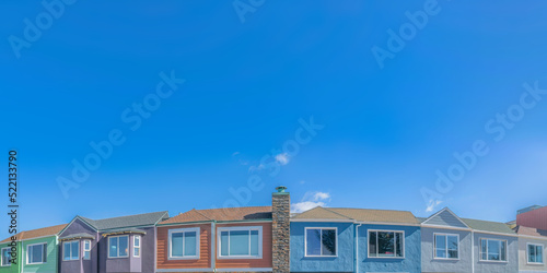 Colorful adjacent suburban houses below the clear sky at San Francisco, California
