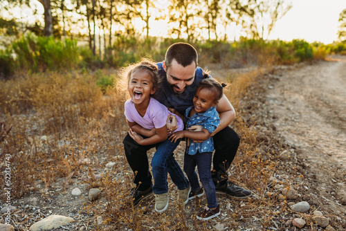 Dad Hugs Girls photo