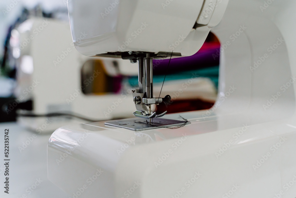 Professional white sewing machine in dressmaker