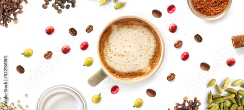 Creative layout made of coffee and spices on the white background. Flat lay. Food concept. Macro concept.coffee,cappuccino,beans,cardamom,cloves,milk,brown sugar on the white background.