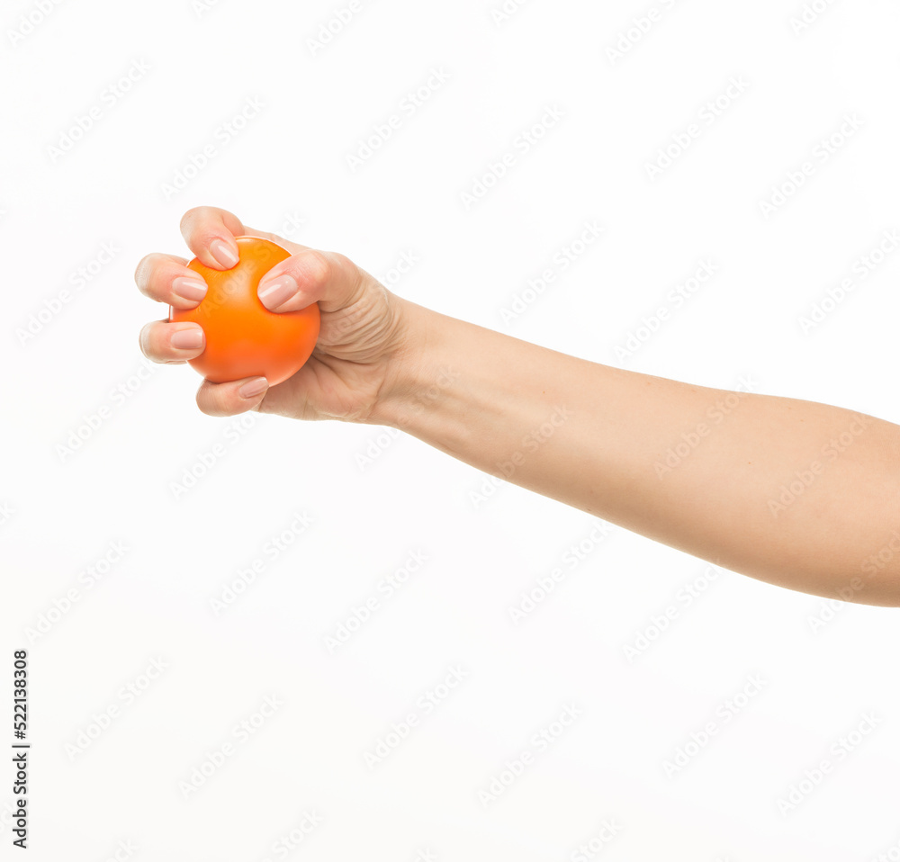 female hands holding an orange sponge ball on a white background isolated female hands holding an orange sponge ball on a white background isolated
