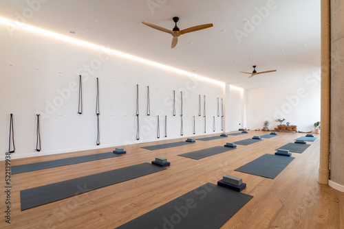 Spacious yoga studio with mats and blocks photo