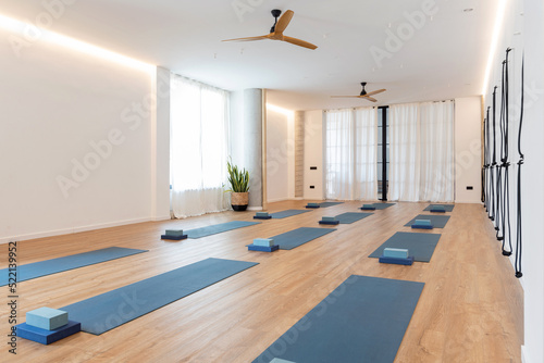 Spacious yoga studio with mats and blocks photo