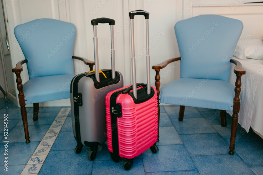 Carry-on trolley suitcases in hotel room Carry-on trolley suitcases in hotel room