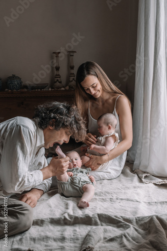Parents Playing With Their Twins 