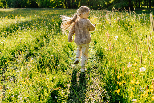 Merry girl running in field