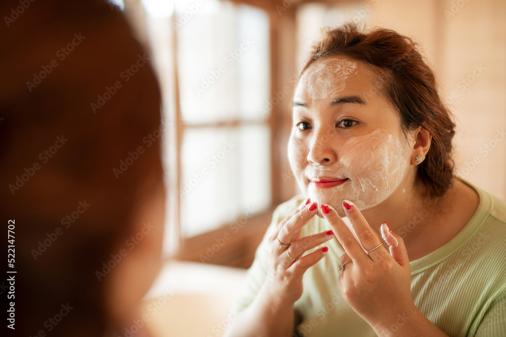 Young plus-size woman washing her face with soap Young plus-size woman washing her face with soap