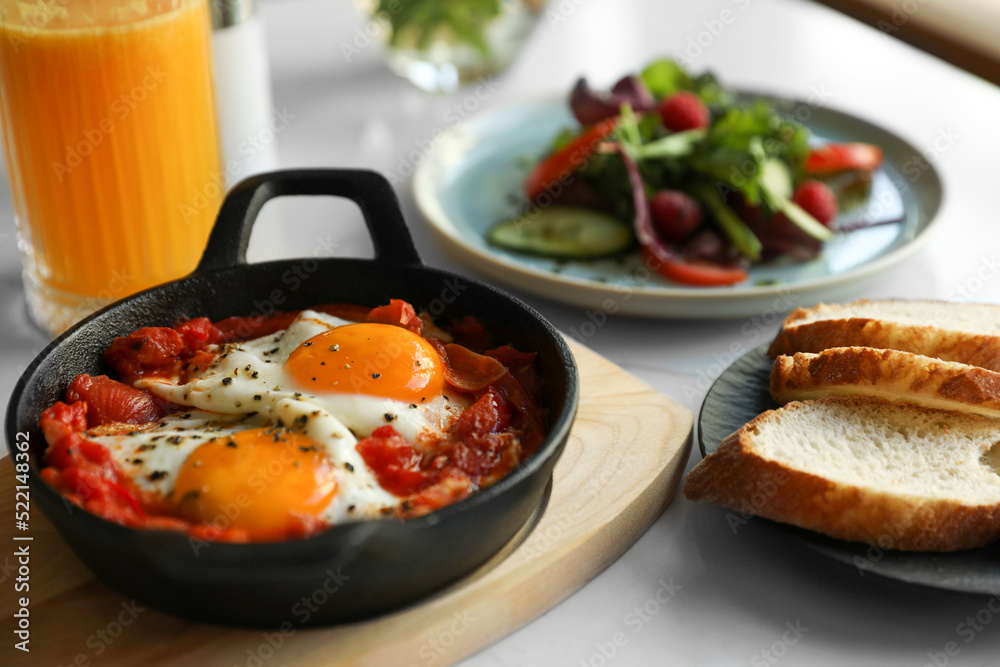 Tasty Shakshouka served on white table. Traditional Arabic dish Tasty Shakshouka served on white table. Traditional Arabic dish