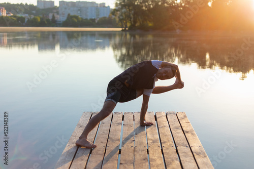 a man performs a heavy asana in yoga photo