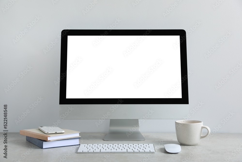 Modern computer with blank screen on light grey table. Mockup for design Modern computer with blank screen on light grey table. Mockup for design