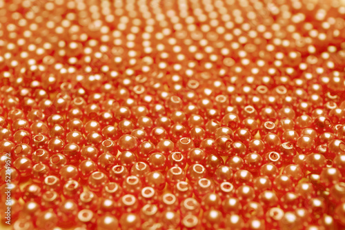 Many bright orange beads as background  closeup