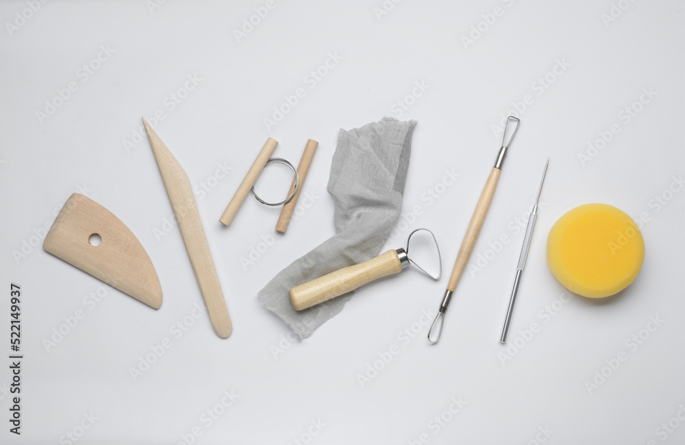 Set of clay modeling tools on white background, flat lay Set of clay modeling tools on white background, flat lay