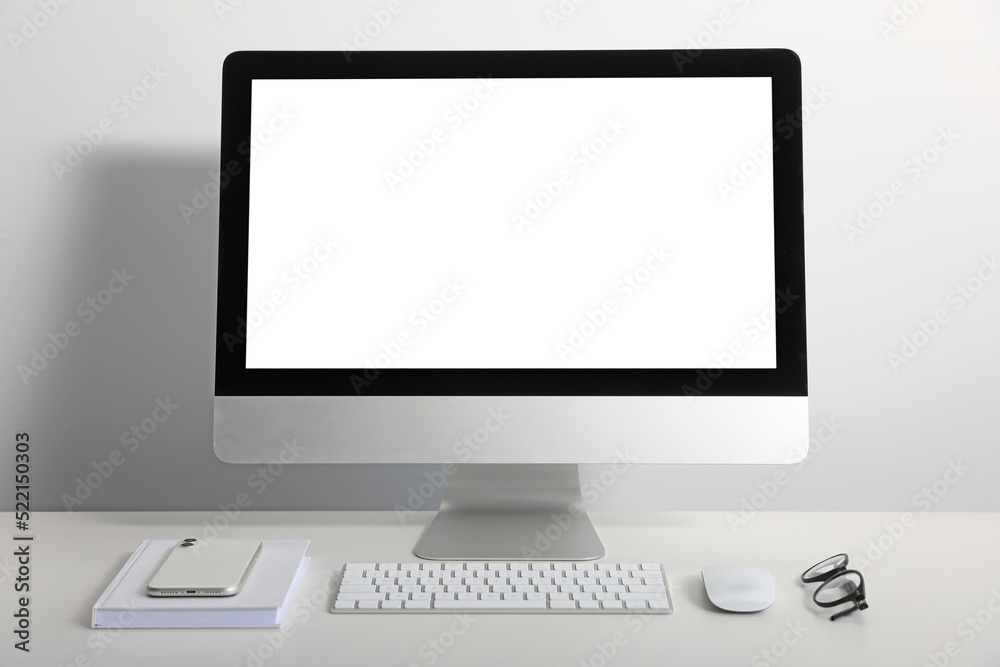 Workplace with modern computer and smartphone on white table. Mockup for design Workplace with modern computer and smartphone on white table. Mockup for design