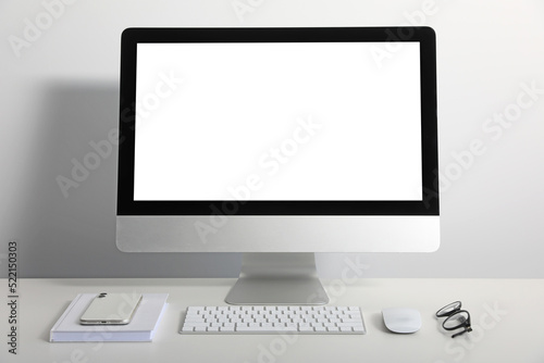 Workplace with modern computer and smartphone on white table. Mockup for design