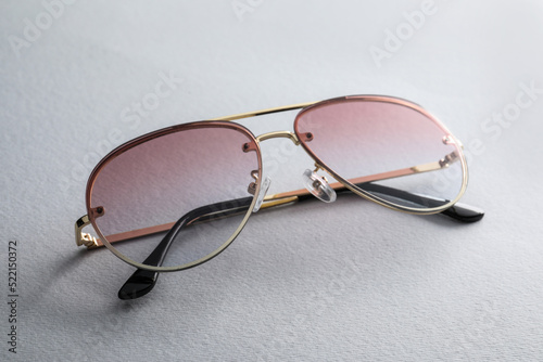 New stylish sunglasses on white background, closeup
