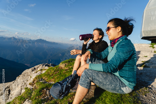 Women sitting on the top of the mountain photo