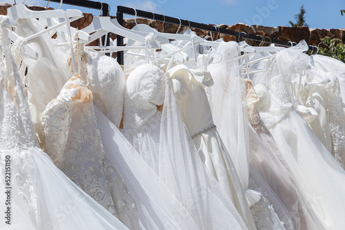 Rack with white wedding dresses