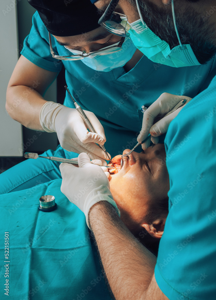 Putting implants during surgery in dental clinic Putting implants during surgery in dental clinic