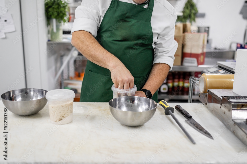 cook preparing food in a restaurant kitchen
cook preparing food in a restaurant kitchen
