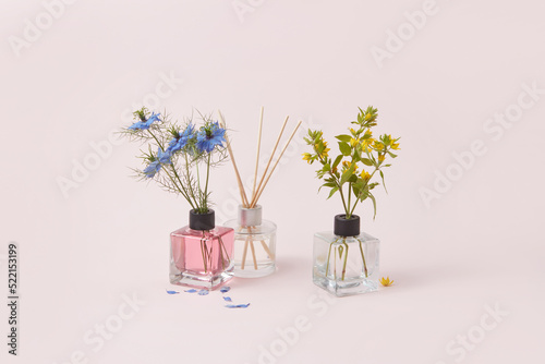 Glass aroma diffusers with garden flowers for decoration. photo