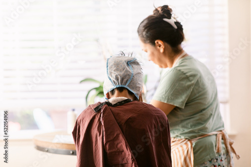 Mom bleaching her son's hair photo