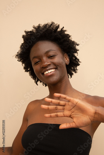 Confiden woman with hand towards camera photo