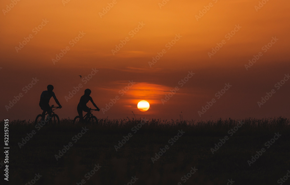 Two mountain bikers on wheat fields Two mountain bikers on wheat fields