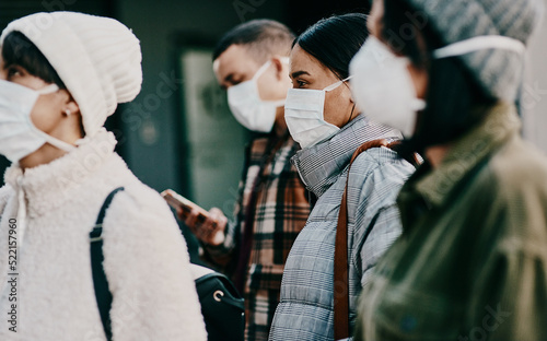 Fotografie, Tablou Traveling people wearing face mask in a covid pandemic in crowd, public or airport border with passport or travel restrictions