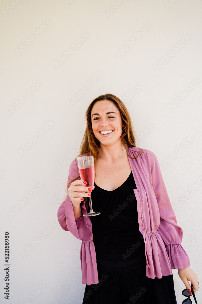 Happy woman celebrating at home with champagne glass Happy woman celebrating at home with champagne glass