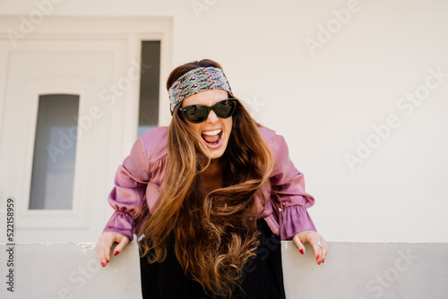 Happy screaming woman sitting on porch