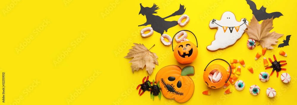 Composition with tasty Halloween treats on yellow background with space for text, top view