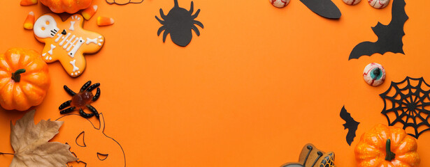 Composition with tasty Halloween treats on orange background with space for text