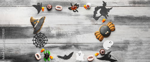 Composition with tasty Halloween treats on grey wooden background with space for text