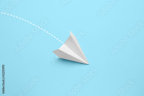 Paper plane on light blue background