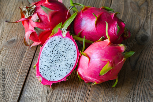 Fresh dragon fruit tropical in the asian thailand healthy fruit concept, dragon fruit cut half on wooden with pitahaya background