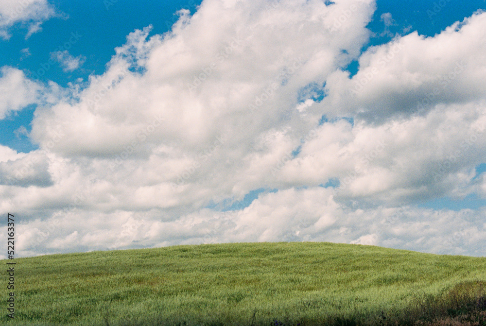 Landscape with a green hill against cloudy sky Landscape with a green hill against cloudy sky